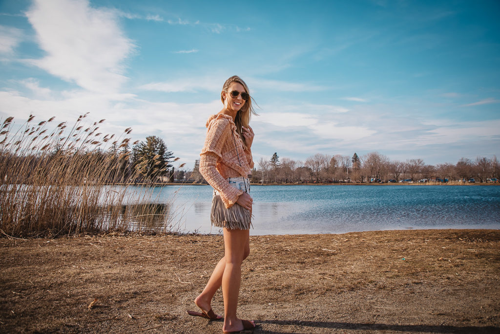 free people crochet sweater & free people shorts with brown laser cut slides and suede fringe crossbody. free people crochet earrings and gucci aviators.